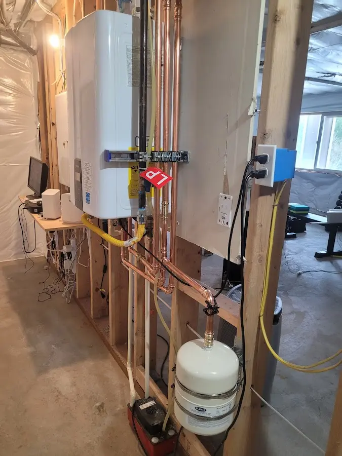 Licensed plumber repairing a kitchen sink in Groton